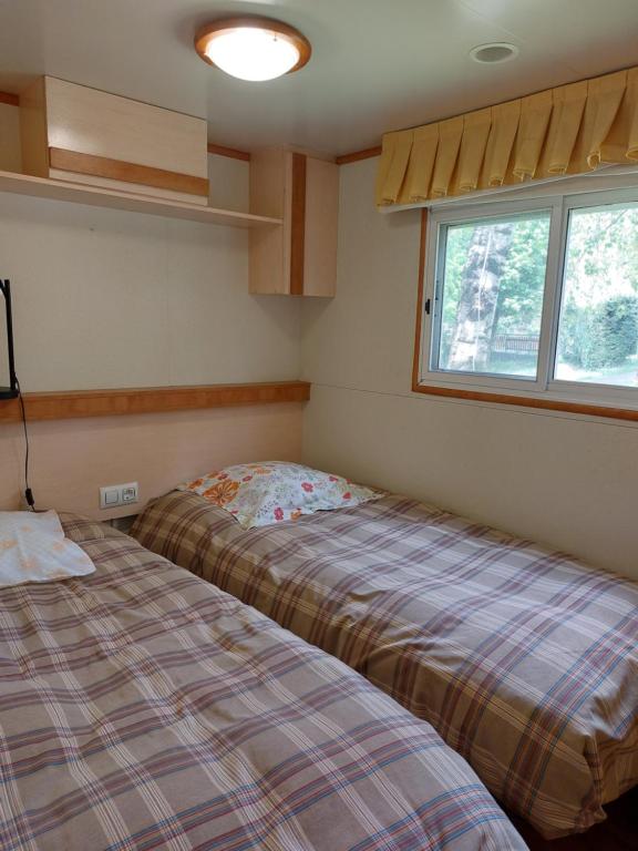 Postel nebo postele na pokoji v ubytování Camping L'Enclave mobil-home