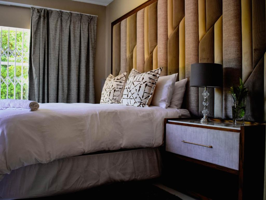 a bedroom with two beds and a window at Serene Guest Manor in Johannesburg