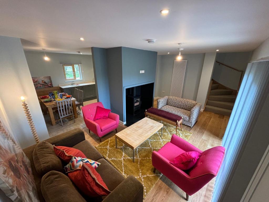 an overhead view of a living room with pink furniture at Ashwood House at Thoulstone Park in Corsley