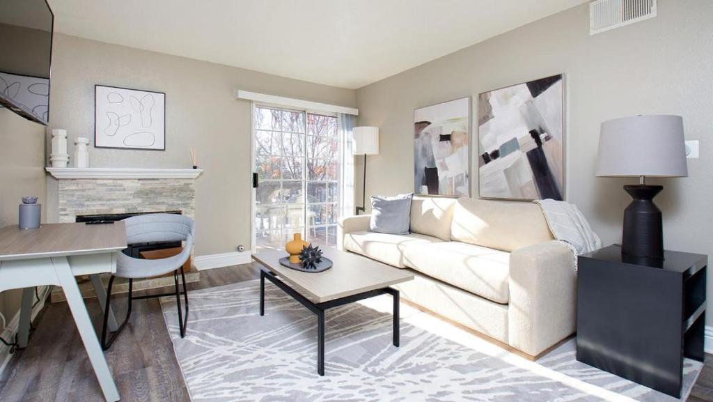 a living room with a white couch and a table at Landing Modern Apartment with Amazing Amenities (ID8118X32) in Temecula