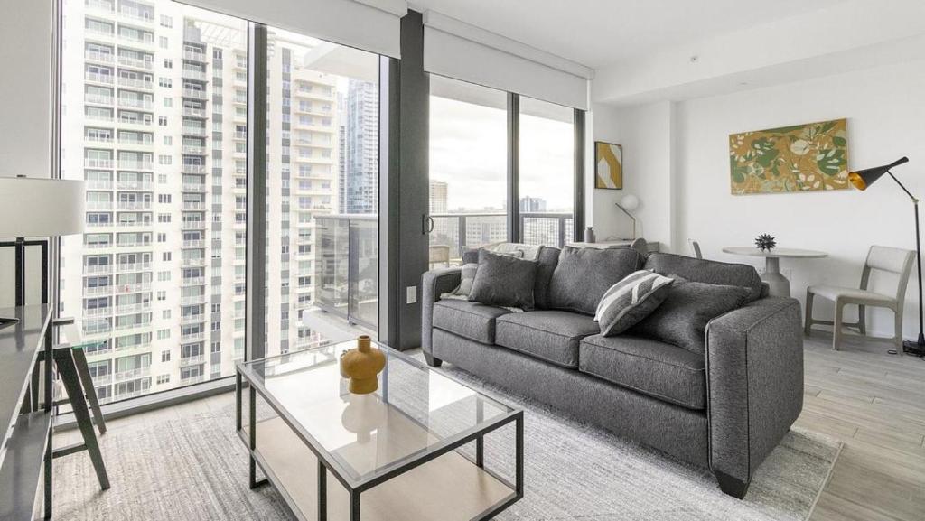 a living room with a couch and a table at Landing Modern Apartment with Amazing Amenities (ID1283X920) in Fort Lauderdale