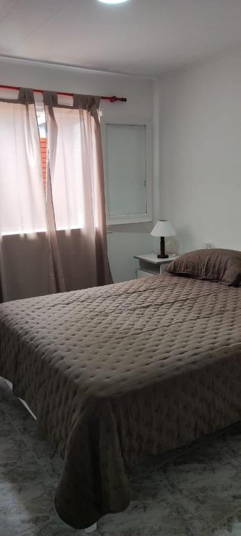 a bedroom with a bed and a window with curtains at SAN BERNARDO in San Bernardo
