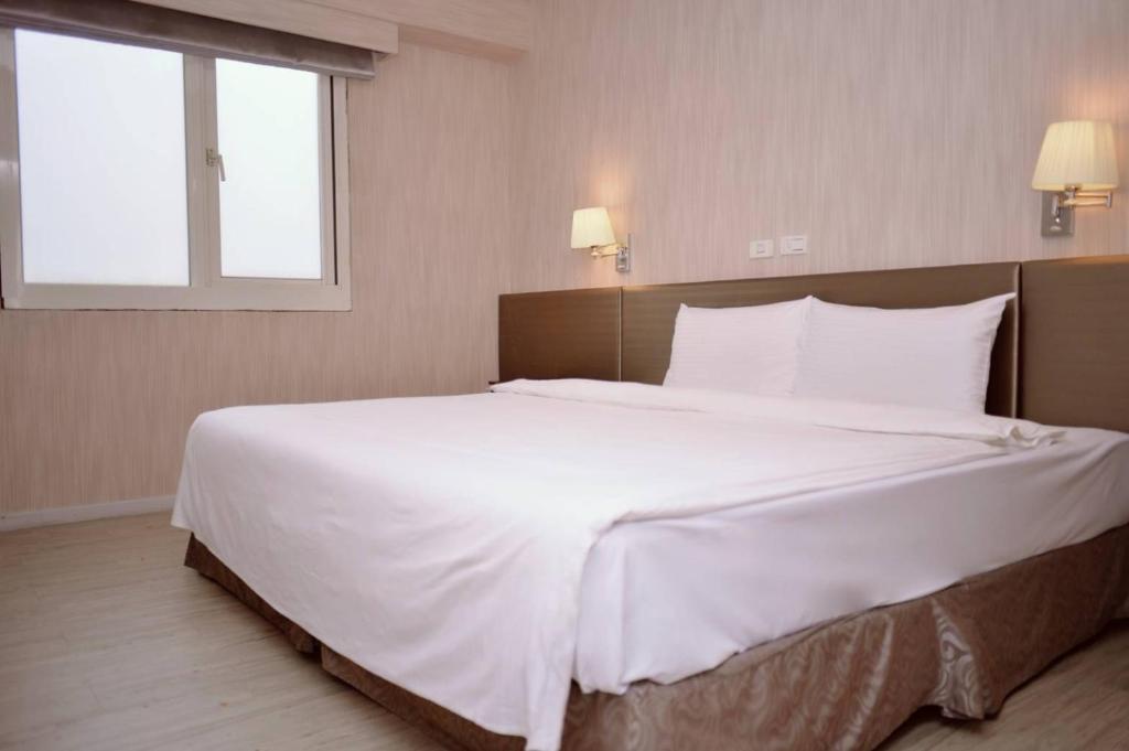 Postel nebo postele na pokoji v ubytování Walker Hotel - Chenggong