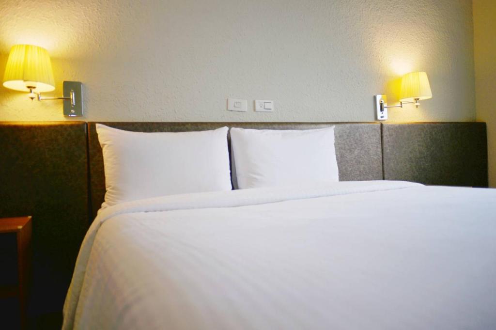 Postel nebo postele na pokoji v ubytování Walker Hotel - Chenggong