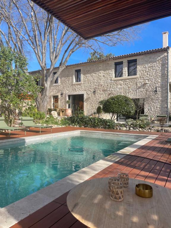 a swimming pool in front of a house at Mas Revive in Grabels