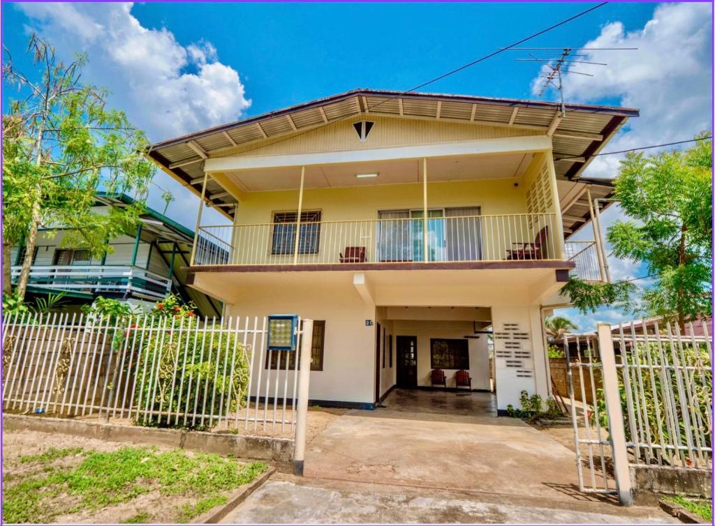 a house with a fence in front of it at 1 Bed Flat - Sleeps 2 - Parking - Wifi in Paramaribo