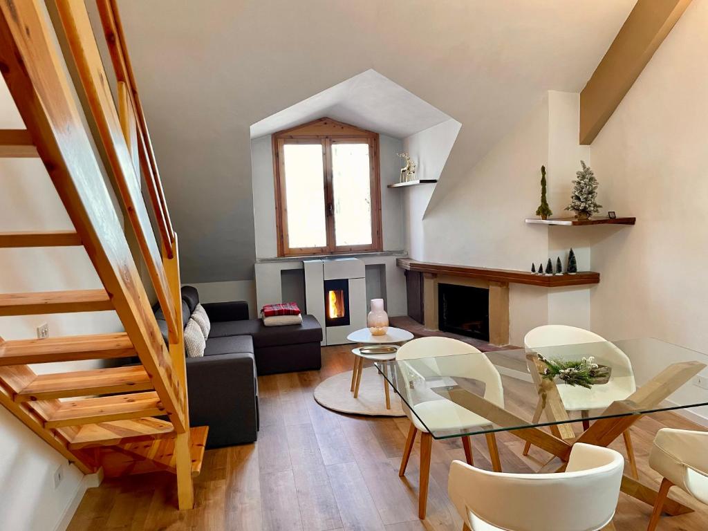 a living room with a glass table and a couch at Amiata Loft Design - Monte Amiata - Free Parking in Seggiano