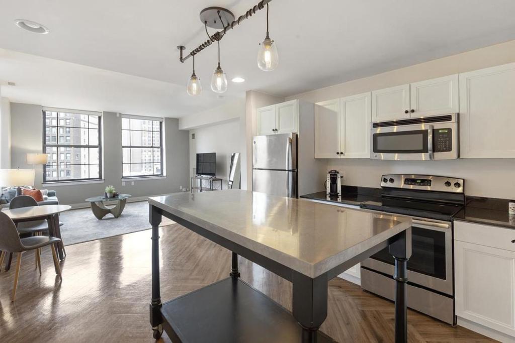 a kitchen with a large island in the middle at Landing Modern Apartment with Amazing Amenities (ID1884X79) in Detroit