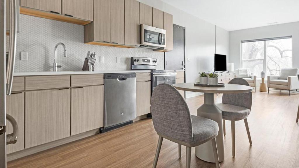 a kitchen and dining room with a table and chairs at Landing Modern Apartment with Amazing Amenities (ID1241X658) in Tower Grove