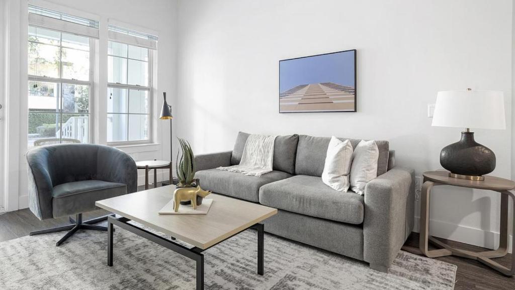 a living room with a couch and a table at Landing Modern Apartment with Amazing Amenities (ID1384X699) in Orlando