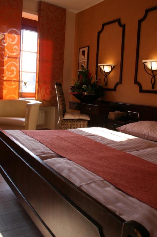 a bedroom with a bed and a desk and a mirror at Le Pavillon in Echternach