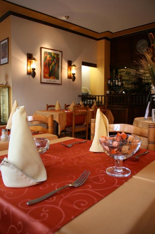 a table in a restaurant with a red table cloth at Le Pavillon in Echternach