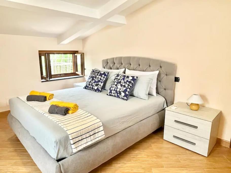 a bedroom with a large bed with blue and white pillows at Intero Appartamento a Sant'Agnello , Le Ortensie in Sant'Agnello