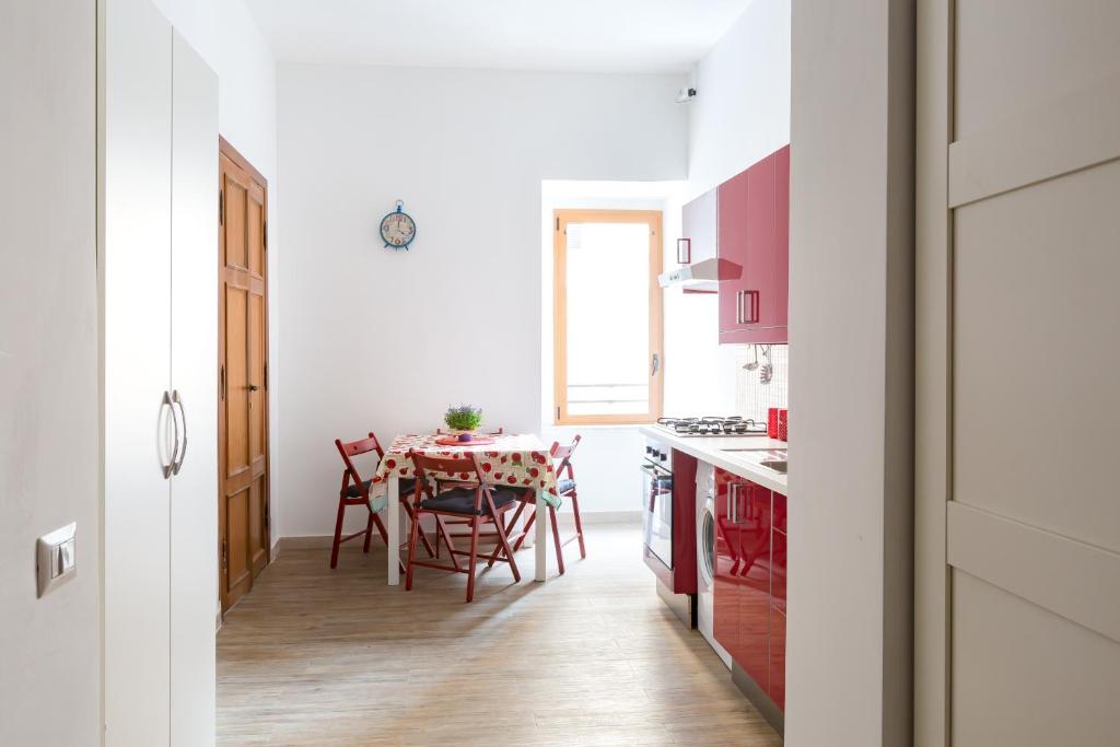 a kitchen and dining room with a table and chairs at New Flat Between The Vatican & Piazza del Popolo in Rome