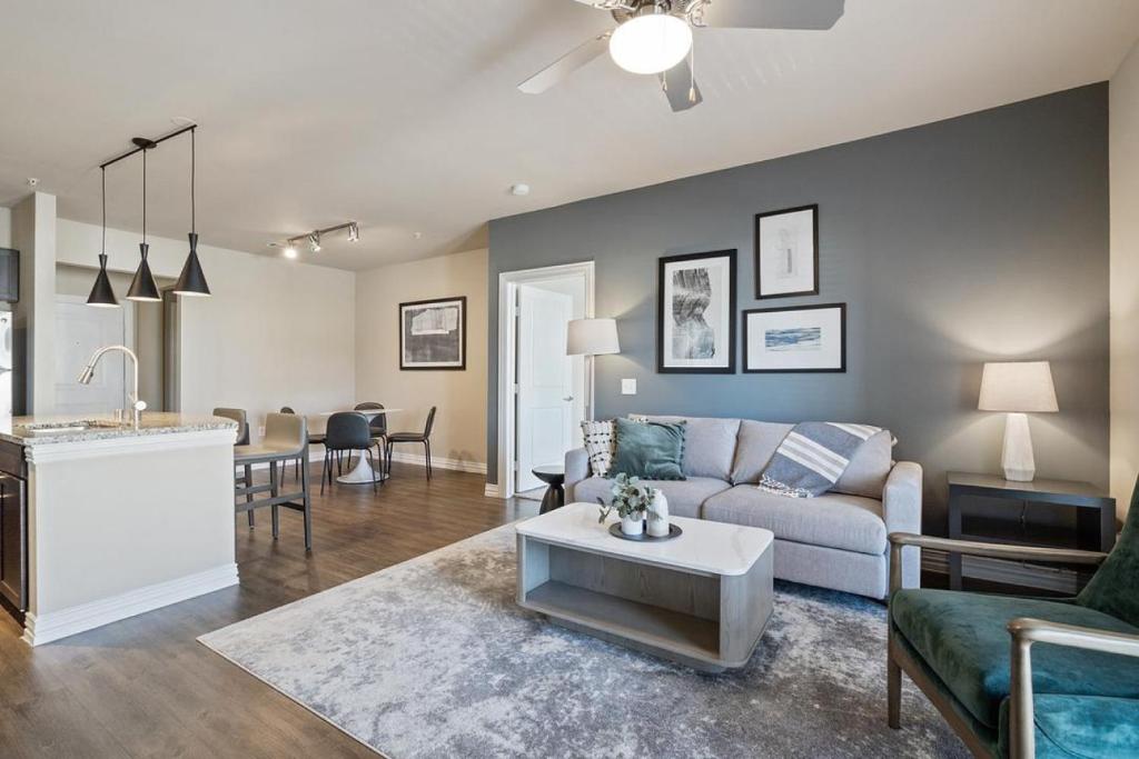 a living room with a couch and a table at Landing Modern Apartment with Amazing Amenities (ID3876) in Carrollton
