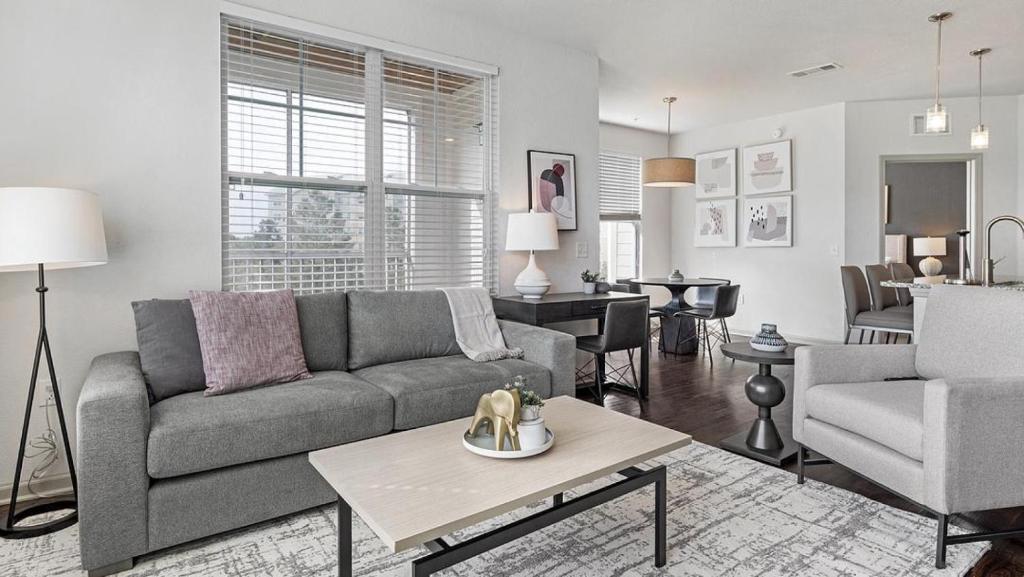 a living room with a couch and a table at Landing Modern Apartment with Amazing Amenities (ID1201X608) in Baton Rouge