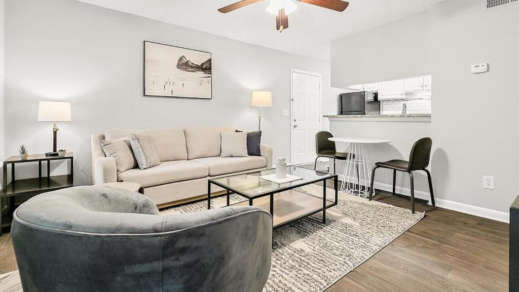 uma sala de estar com um sofá e uma mesa em Landing Modern Apartment with Amazing Amenities (ID6735X37) em Greensboro