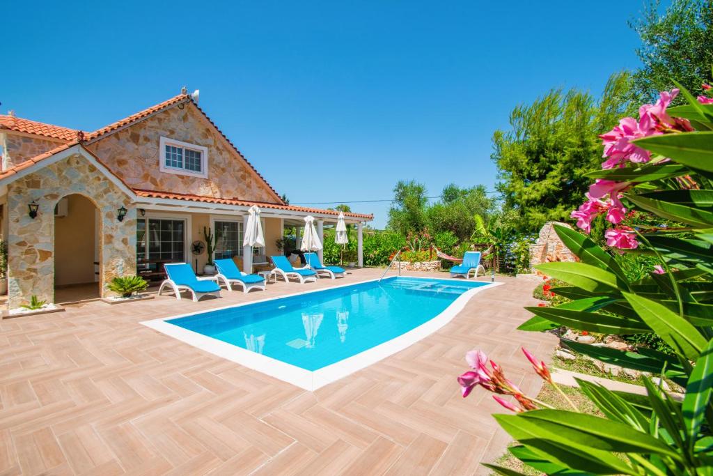 a villa with a swimming pool and a house at Zante Sun I - Getaway Villa! in Zakynthos