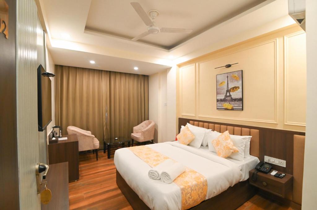a hotel room with a bed and a desk at Hotel Ramida Plaza At Delhi Airport in New Delhi
