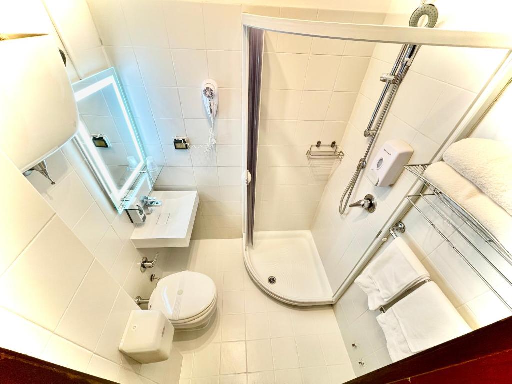 a bathroom with a shower and a toilet at Hotel S. Ercolano in Perugia