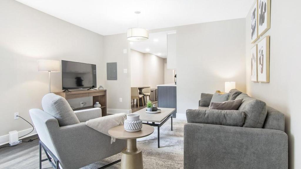 a living room with two couches and a tv at Landing Modern Apartment with Amazing Amenities (ID8363X48) in Arlington