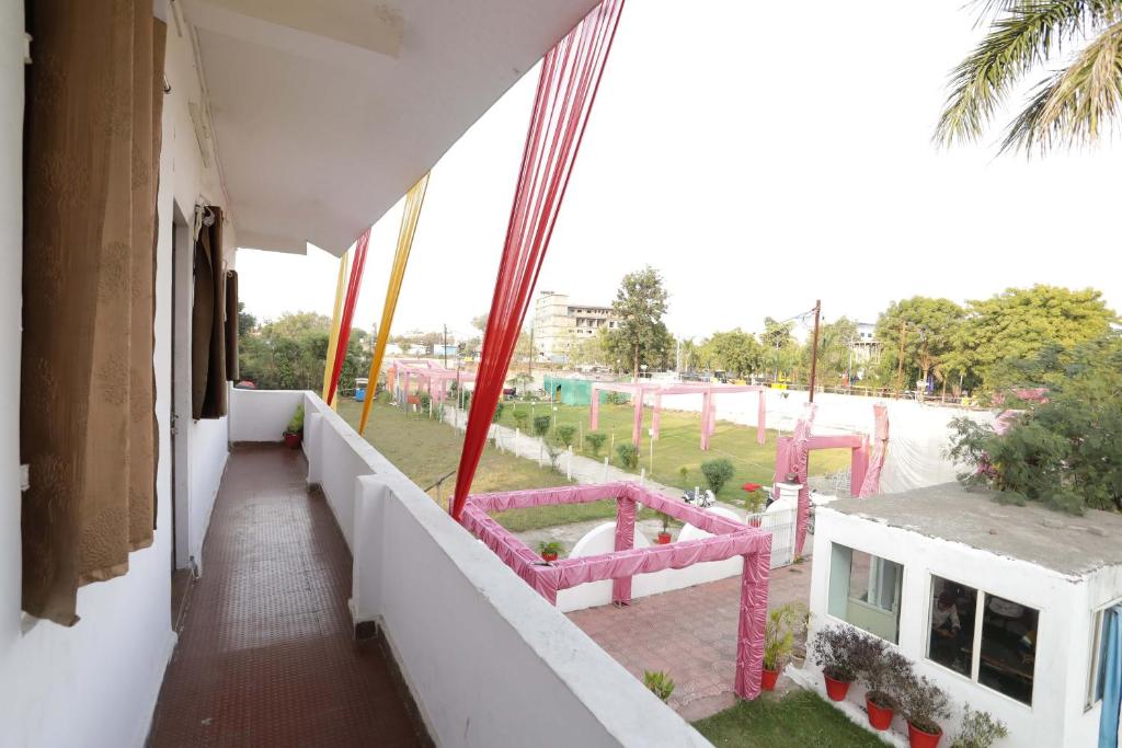 a balcony with a view of a playground at OYO Hotel Shahnai Garden in Bhopal