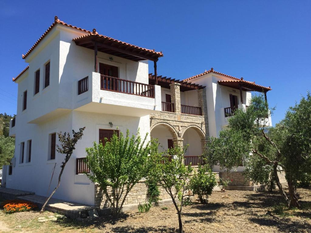 a large white house with a balcony at Gaia Apartments By Villa Kokkoni in Marathokampos