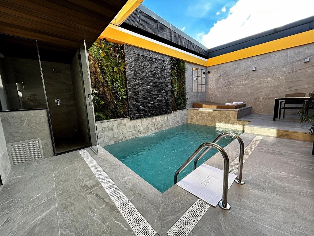 a swimming pool in the middle of a house at Zouk Hotel in Alcalá de Henares