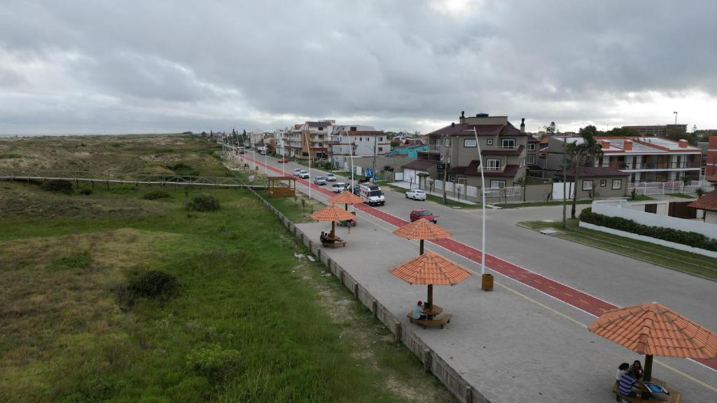 a street with orange umbrellas on the side of a road at Pousada Vista da Barra in Cassino