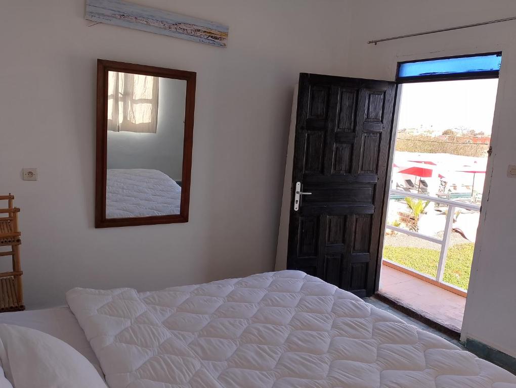 A bed or beds in a room at Riad Ocean Beach Douira