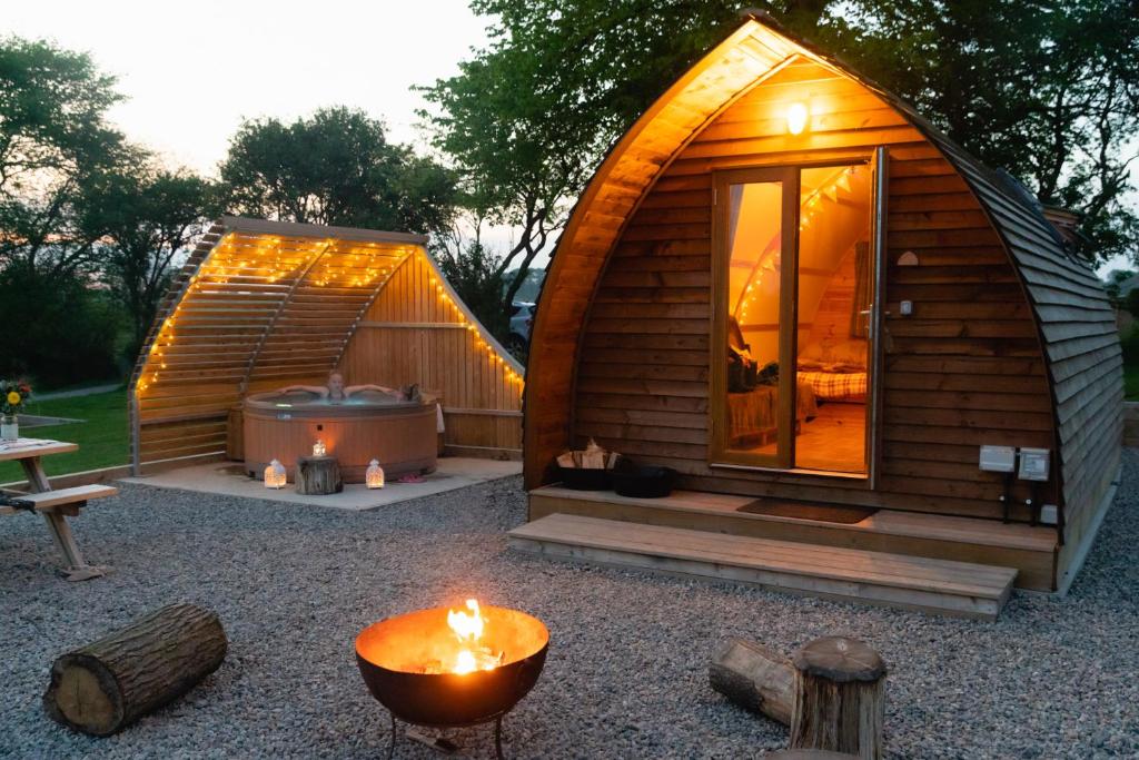 a small wooden cabin with a hot tub and a grill at Sedgewell Barn in Northallerton