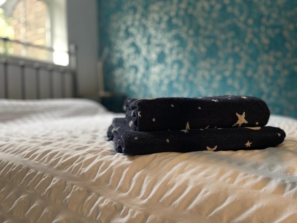dos toallas sentadas encima de una cama en Barwell Manor - Master room 