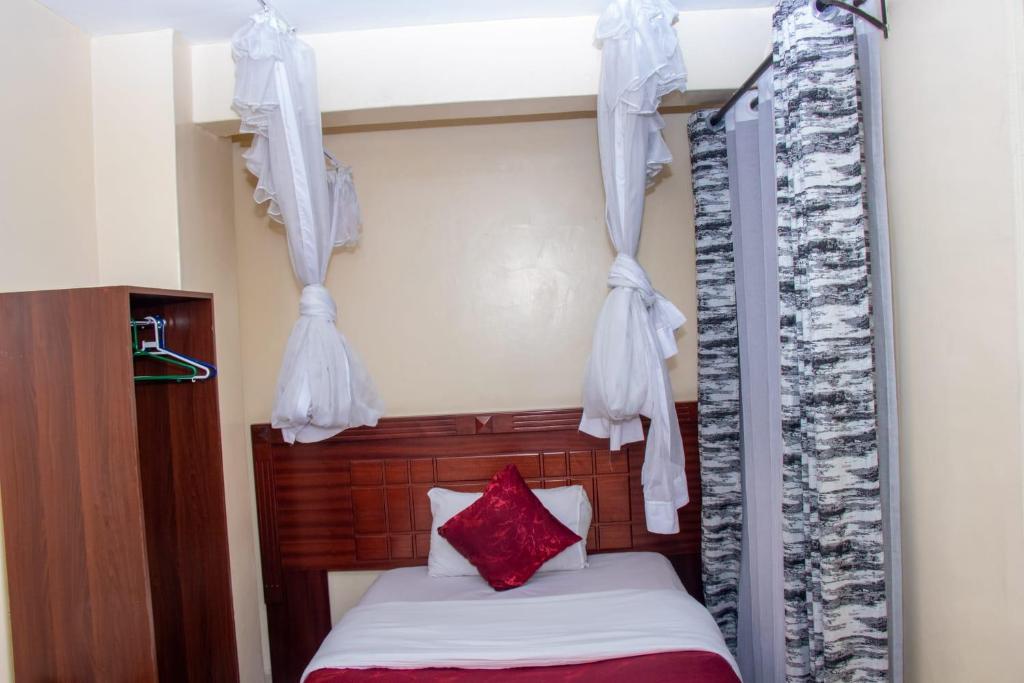 Postel nebo postele na pokoji v ubytování Epitome Times Hotel