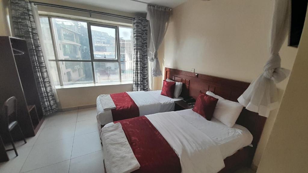 Postel nebo postele na pokoji v ubytování Epitome Times Hotel