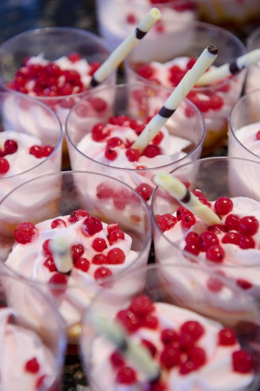 a group of cups filled with desserts with cherries in them at H10 Ocean Suites in Corralejo