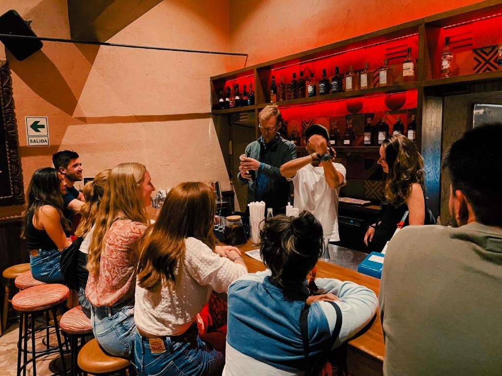 a man standing at a bar with a group of people at Viajero Cusco Hostel in Cusco