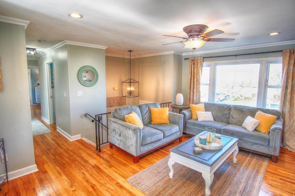 a living room with a couch and a table at Gorgeous beach house with large pool & private beach, just 3 blocks away!! in Point Pleasant Beach