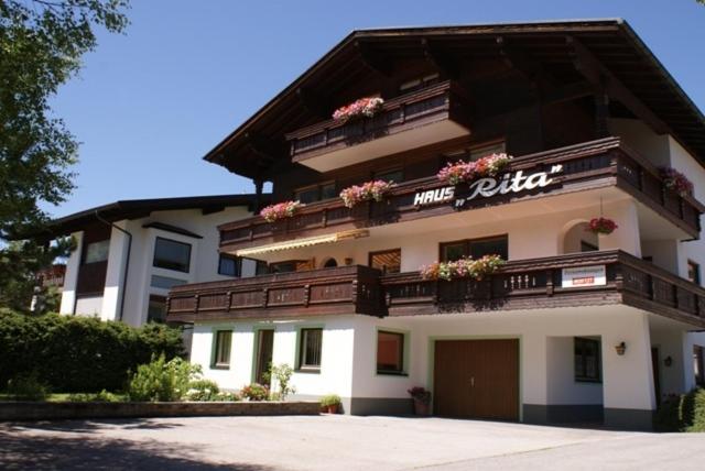 a large white building with flowers on the balcony at Haus Rita in Berwang