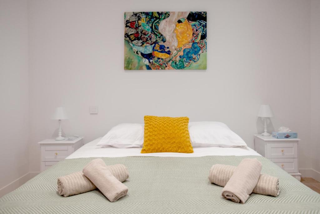 ein Schlafzimmer mit einem Bett mit zwei Kissen darauf in der Unterkunft Apparts Gambetta in Libourne