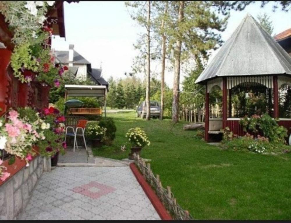 a garden with a gazebo and a house at Vila Miris borova Zlatibor CENTAR in Zlatibor