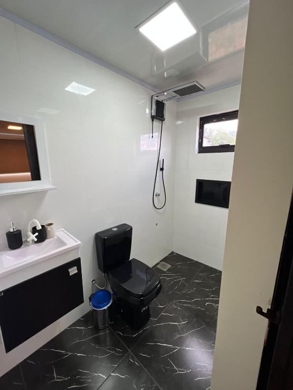 a bathroom with a toilet and a sink at Container Home Py in Puerto Presidente Franco