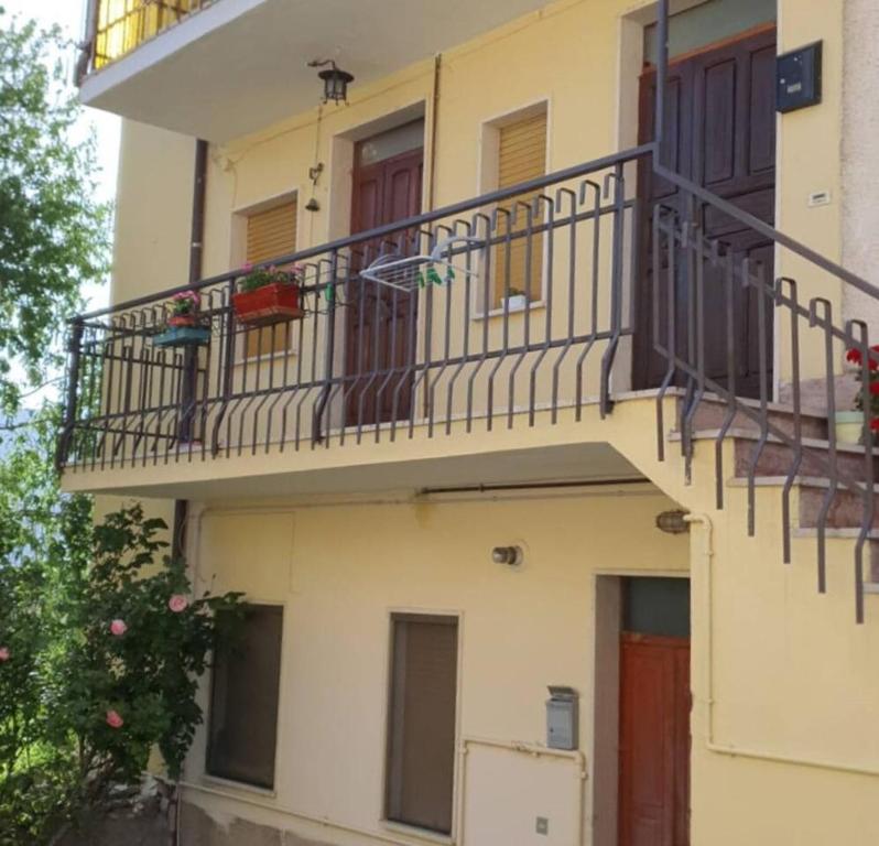 an apartment building with a balcony and a staircase at 2 bedrooms appartement at Lucoli in Casavecchia