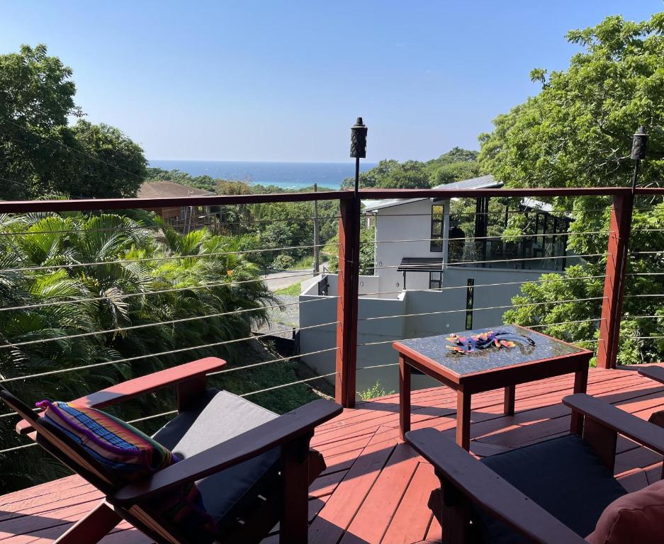 a patio with a table and chairs on a deck at Casa Maya in West Bay