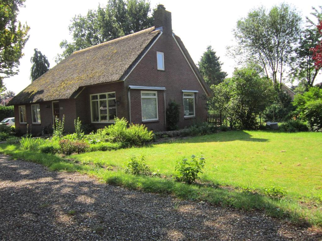 een klein huis met een grasveld ervoor bij B&B Loon in Loon