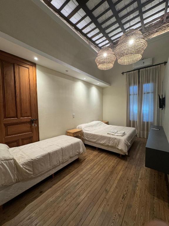 a bedroom with two beds and two chandeliers at Florida 55 in Salta