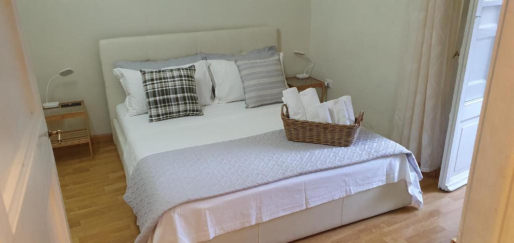 a bedroom with a bed with a basket on it at Rome Apartment Colosseo S 1 Floor in Rome