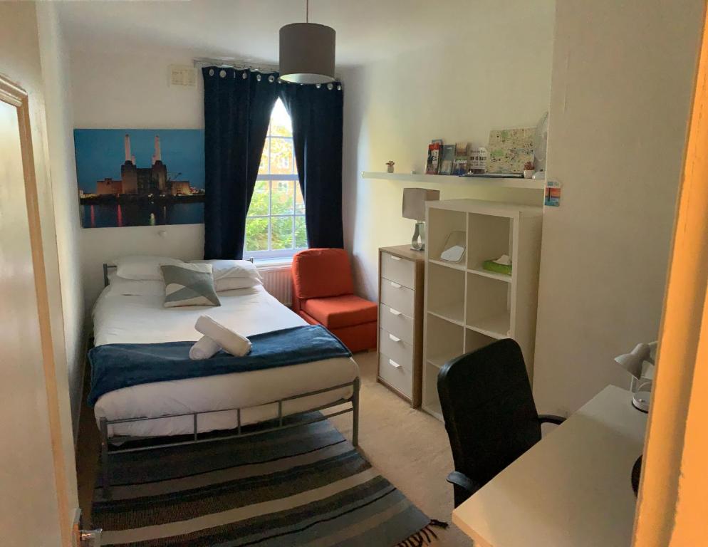a small bedroom with a bed and a window at CENTRAL LOCATION! Double Bedroom 2 Mins Walk from Battersea Power underground Station! in London