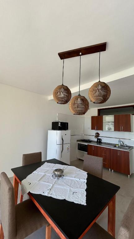 a kitchen with a black table and a kitchen with a refrigerator at Temporarios Alfonso in Santa Fe