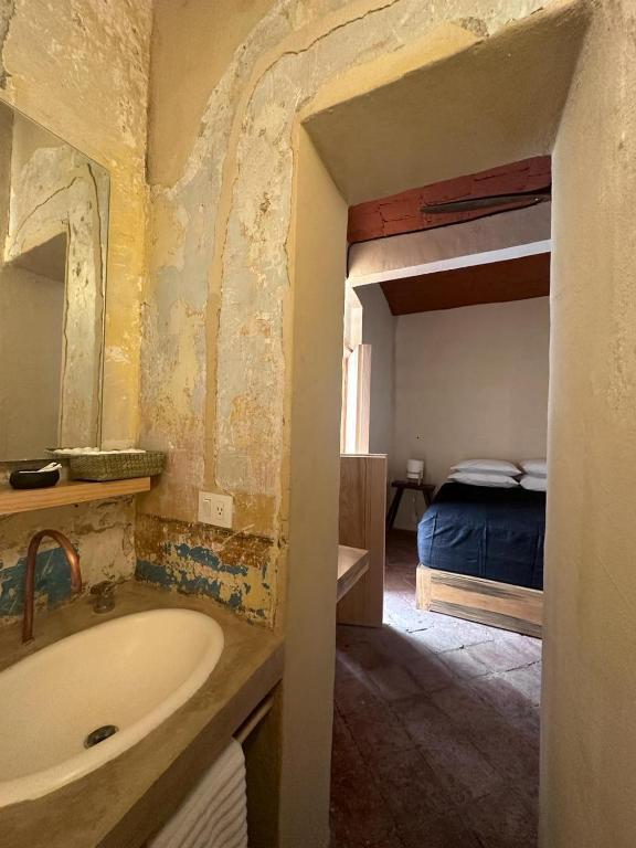 Postel nebo postele na pokoji v ubytování CASA PENUMBRA- Centro Oaxaca