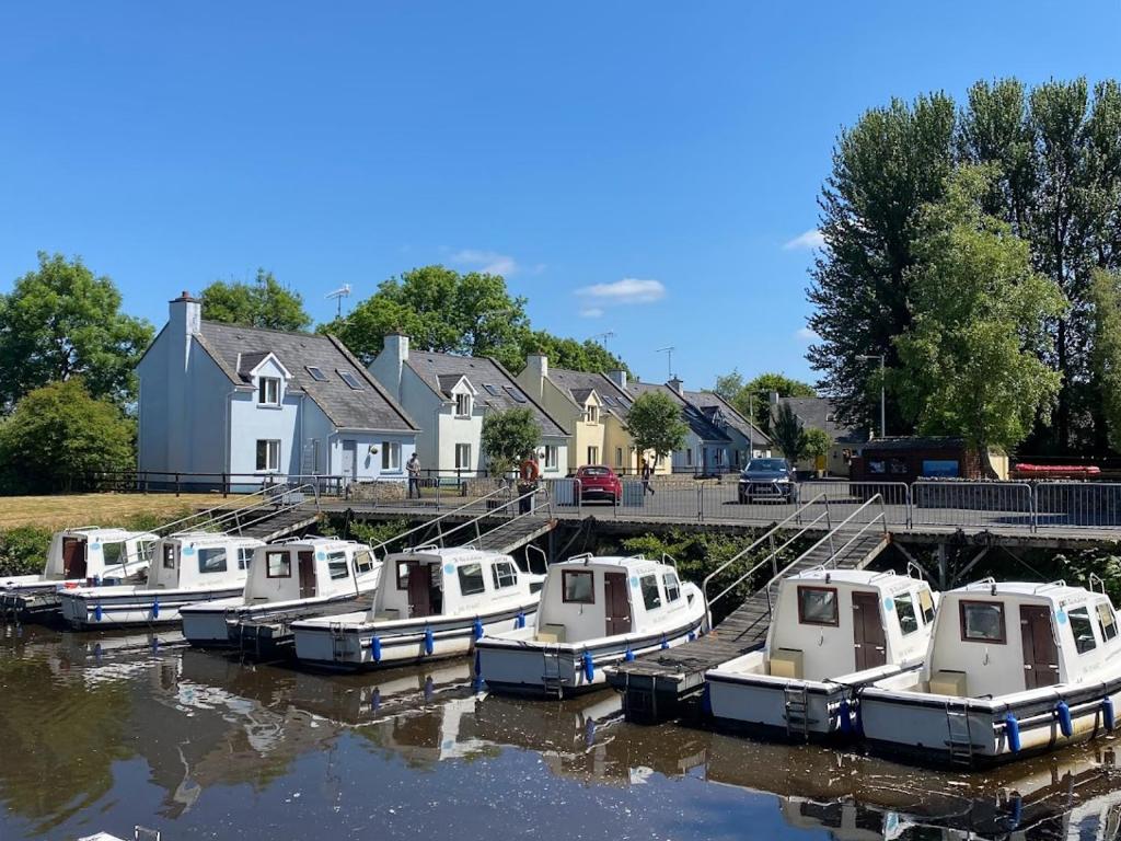 a group of boats are docked in the water at Leitrim Quay - Riverside Cottage 3 in Leitrim
